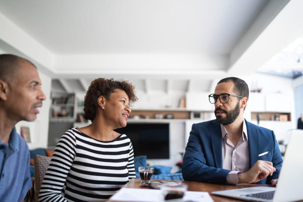 Couple talking to financial advisor at home