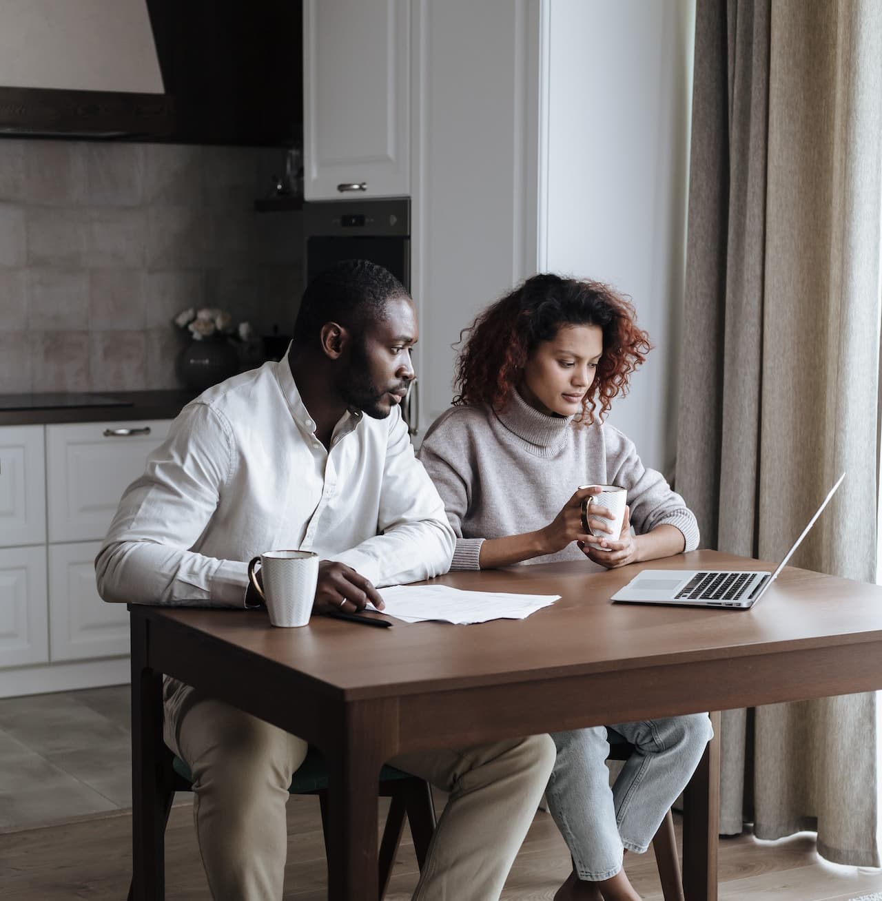 A couple viewing information on a laptop